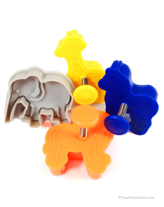 DIY Clay Elephant Christmas Ornaments. Quick to make, fun to gift. Animal Cracker cookie cutters make such cute little ornaments.