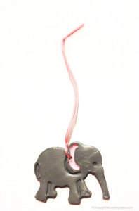 DIY Clay Elephant Christmas Ornaments. Quick to make, fun to gift. Animal Cracker cookie cutters make such cute little ornaments.