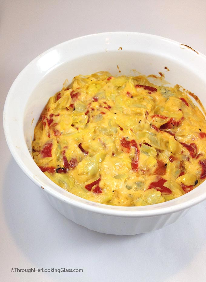 Baked Cheesy Artichoke Dip. Mmmmm. Creamy, melty parmesan, garlic, artichokes and sweet roasted red peppers. Serve with veggies, pita chips, blue corn chips