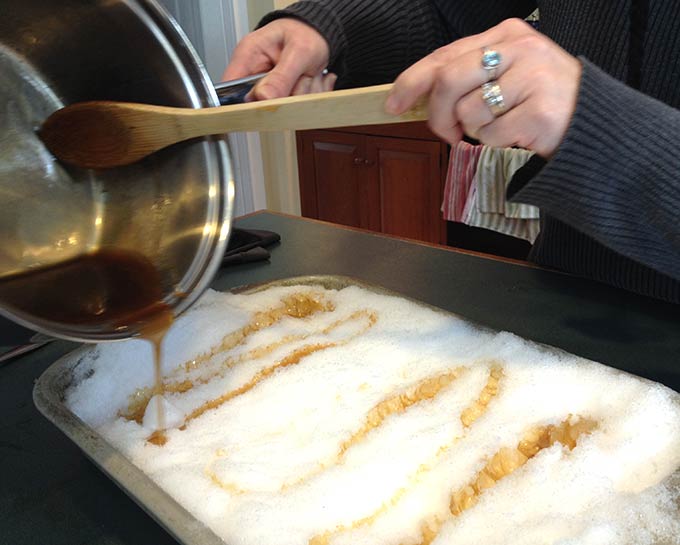 Delicious Maple Taffy on Snow. An old-fashioned French tradition. Boil the syrup, sugar, butter and vanilla. The taffy caramelizes and hardens on the snow.