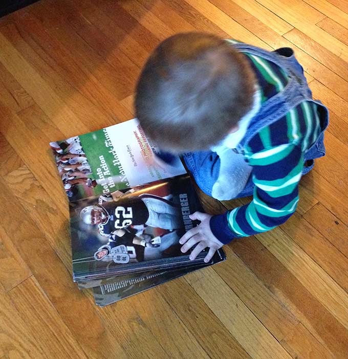 Biggest Little Fan. Hudson loves a good football game, the Pats in particular. Then we noticed him with the old 2010 New England Patriots yearbook.