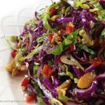 Crunchy Asian Salad with light, sweet dressing. Gorgeous salad with big crunch. Cabbage, red peppers, toasted ramen noodles, almonds and sesame seeds.