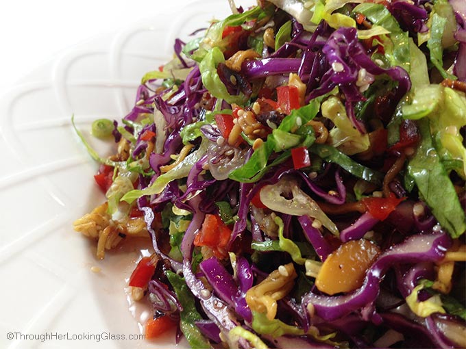 Crunchy Asian Salad with light, sweet dressing. Gorgeous salad with big crunch. Cabbage, red peppers, toasted ramen noodles, almonds and sesame seeds.