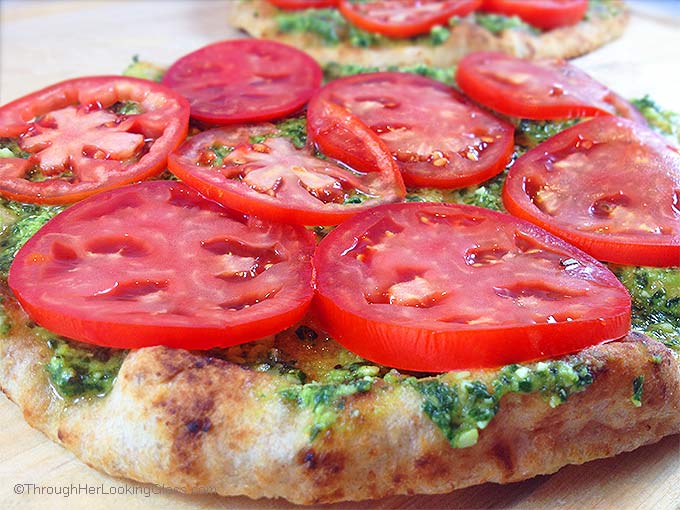 Caprese Pesto Flatbread. Fresh basil pesto, tomatoes, fresh mozzarella and drizzle of balsamic vinegar combine for a fresh & delicious flatbread pizza.