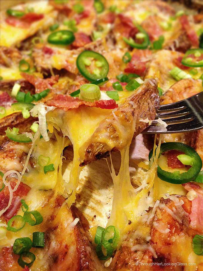 Cheesy Jalapeno Bacon Steak Fries: scrumptious appetizer or main dish. Crispy cheese smothered steak fries w/ bacon crumbles, green onions & jalapenos.