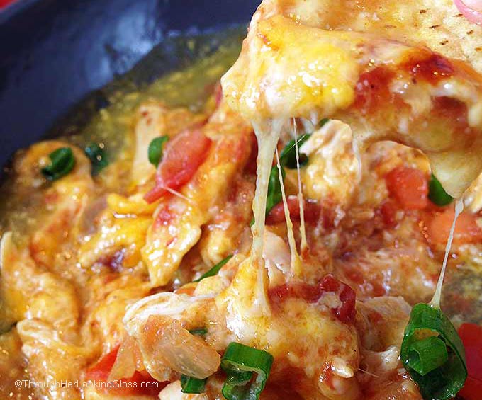 Chipotle Queso Fundido Skillet. Melty, stretchy, molten cheese. Shredded chicken and salsa, tomatillo & chipotle sauces. Smoky, spicy and sweet!