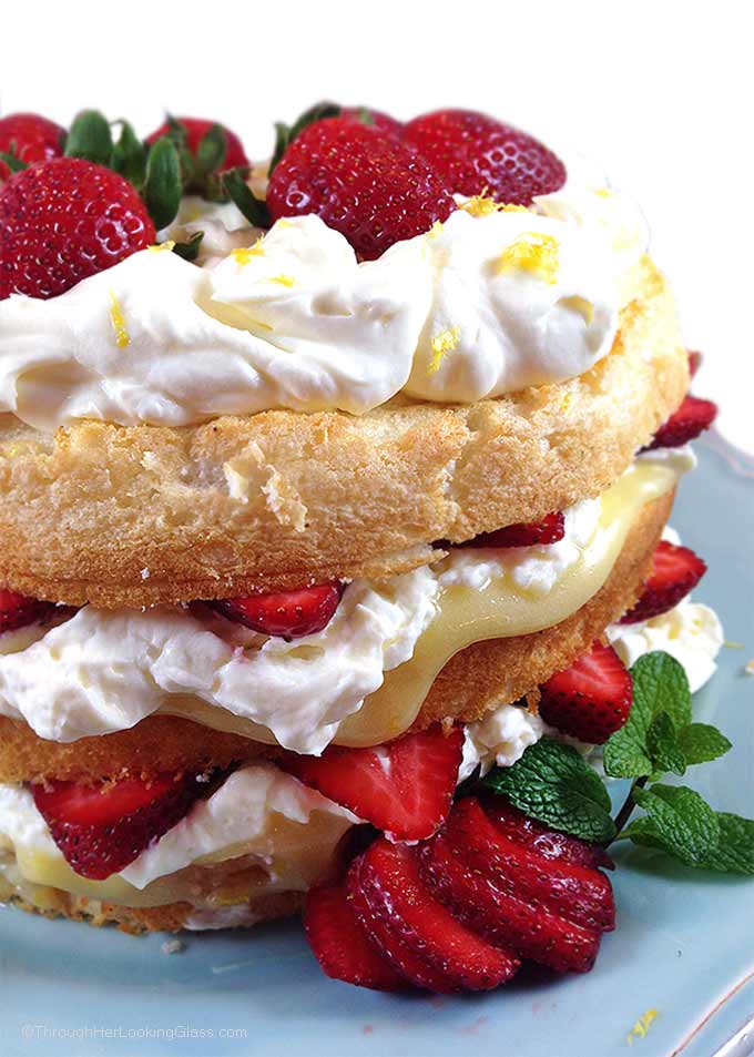 Fresh Strawberry and Lemon Angel Food Cake. Cake layers with fresh strawberries, lemon curd and homemade lemon whipping cream. Stunning and easy dessert!