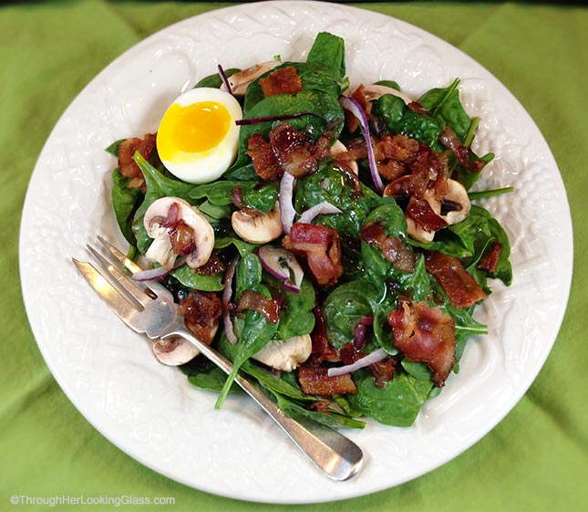 Maple Warm Bacon Dressing Spinach Salad: sweet maple syrup combines with warm bacon dressing atop spinach greens. Eating your greens never tasted so good!