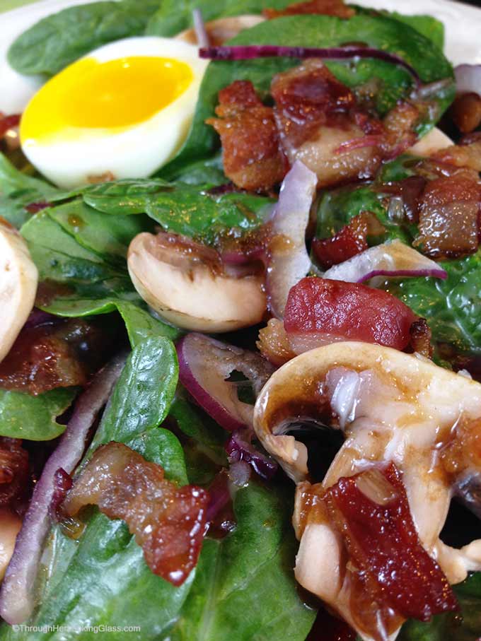 Maple Warm Bacon Dressing Spinach Salad: sweet maple syrup combines with warm bacon dressing atop spinach greens. Eating your greens never tasted so good!