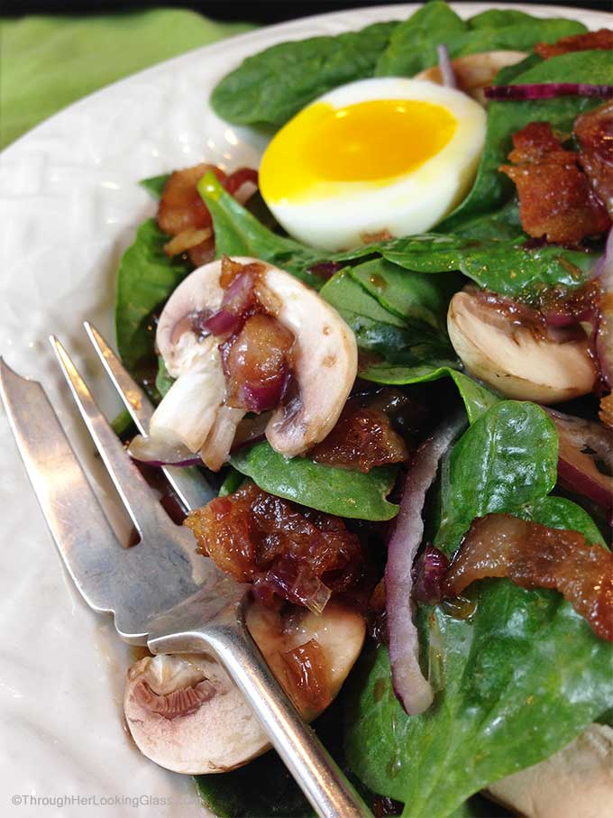 Maple Warm Bacon Dressing Spinach Salad: sweet maple syrup combines with warm bacon dressing atop spinach greens. Eating your greens never tasted so good!