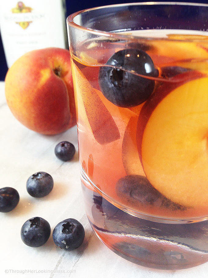 Easy and fruity: Make White Wine Peach Sangria by the pitcherful! Sweet peaches macerate in a delicious cocktail for all the pool & patio summer parties!