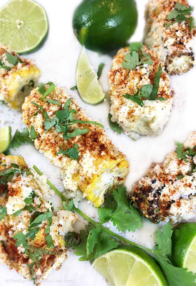 This Charred Mexican Street Corn Recipe is so easy! Grilled corn on the cob w/crumbled cotija, sprinkled w/chili powder, spritzed with lime. Heavenly!