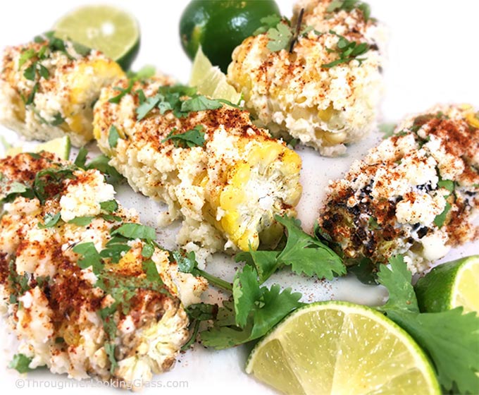 This Charred Mexican Street Corn Recipe is so easy! Grilled corn on the cob w/crumbled cotija, sprinkled w/chili powder, spritzed with lime. Heavenly!