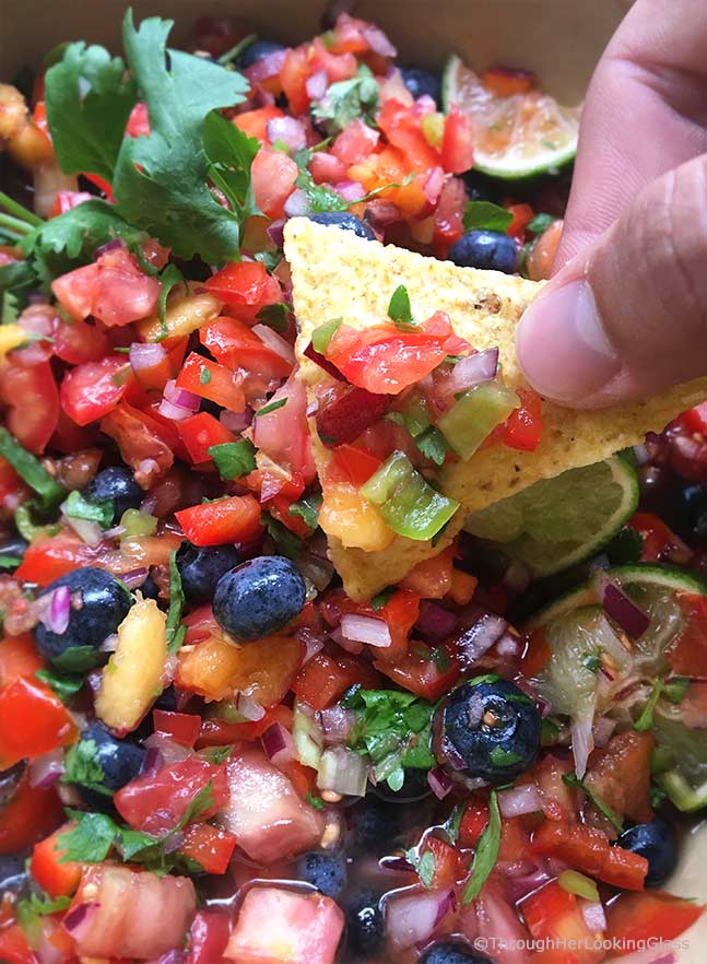 Fresh Peach Blueberry Salsa: fruity salsa with a delicious bite! This fresh salsa is so addictive. The peaches and blueberries are a sweet surprise!