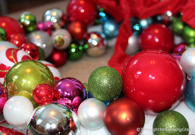 This Willy Wonka Christmas Ball Wreath is a fun and sparkly way to welcome in the Christmas holidays. Easy to make too. Just hot glue Christmas ornaments of various colors, shapes and sizes onto a styrofoam wreath form.